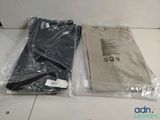 two bags of clothing sitting on the floor next to each other