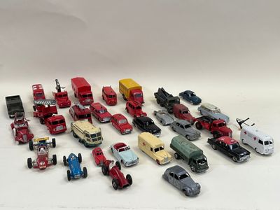 a lot of toy cars and trucks on a white surface