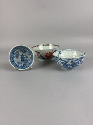 three blue and white bowls with designs on them sitting on a table
