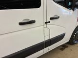 a white van with black trims parked in a garage