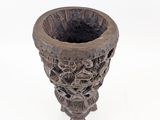 a small vase that is sitting on a white surface