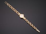 a gold watch with a white dial on a gold bracelet