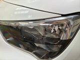 a close up of a car ' s headlight with a mirror on it