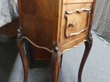 a small wooden table with a drawer on top of it