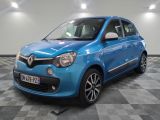 the small blue car is parked in a room with a checkered floor