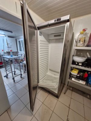 an image of a refrigerator in a kitchen with a door open