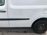 a white van parked in a parking lot next to a building