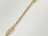 a gold chain bracelet with a heart charm on it