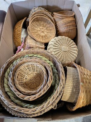 a box full of wicker baskets sitting on the floor