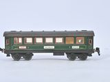 a small green train car on a white surface