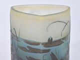 a glass cup that has a picture of a boat on it