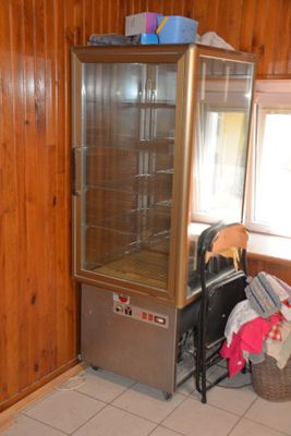 an image of a kitchen with wood paneling and tile flooring