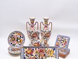 many pieces of pottery that are sitting on a table