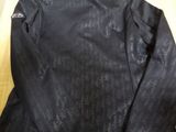 a black jacket sitting on top of a wooden table