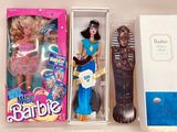 a barbie doll and a hair brush in a box