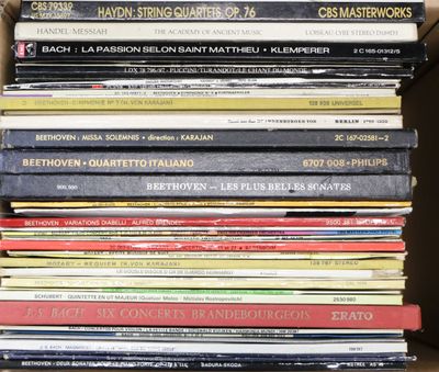 many books stacked on top of each other in a box
