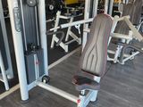 a gym room with a variety of machines in it