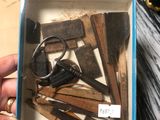 someone is holding a box with a bunch of keys and a pair of scissors