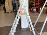 two ladders sitting on the floor in a store