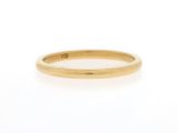 a yellow gold wedding band with a single diamond in the center