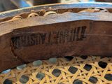 a close up of a wooden chair with a label on it