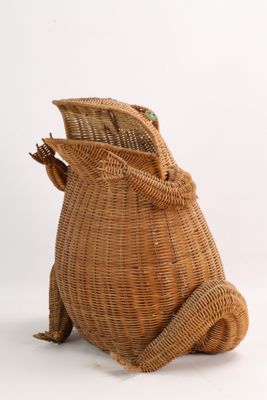 a wicker bag with a frog on it ' s back
