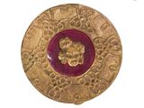 an image of a gold and red broochle