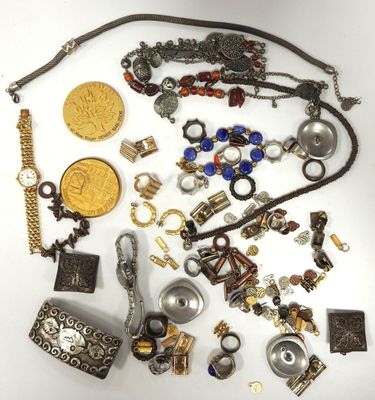 a lot of jewelry that is laying out on the table