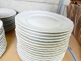 many plates stacked on top of each other on a shelf