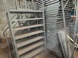 many shelves that are stacked up in a warehouse