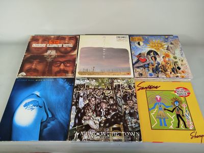 a lot of vinyl records on a glass table