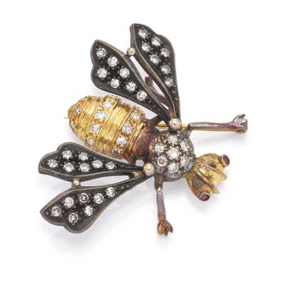 a close up of a gold and diamond insect broochle