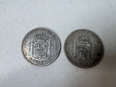 two silver coins with a coat of arms on them