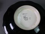 underside view of a black and white bowl with a black rim