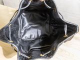 a black purse sitting on top of a wooden table