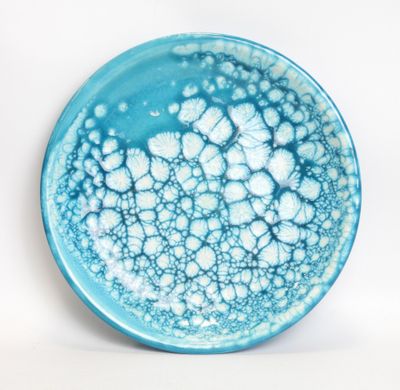 blue and white plate with bubbles on it on a white surface