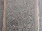 an old book sitting on top of a gray surface
