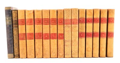 several old books are lined up in a row on a white surface