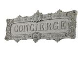 an old cast iron sign with the name of a city on it