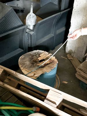 a man that is cutting a piece of wood with a knife