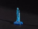 a blue glass figure that is standing on a black surface