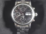 a close up of a watch on a black surface