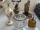 une table blanche sur laquelle sont posés un vase et une lampe