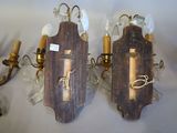 two sconces are mounted on a wall next to a candle holder
