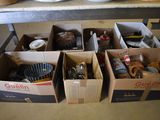 several boxes of assorted items sit on a table in a kitchen