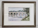framed watercolor painting of a bridge over a river in a frame