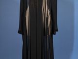 an image of a black dress on a mannequin stand