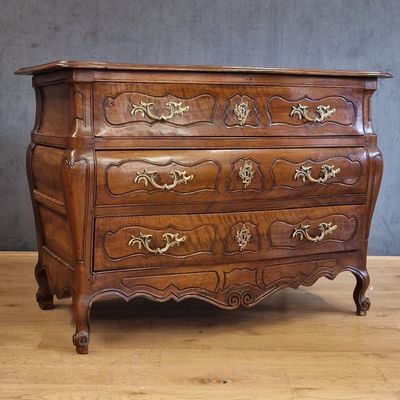 a wooden chest of drawers on a wooden floor