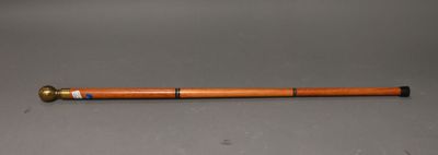 an old wooden pipe with a brass fitting and a wooden handle
