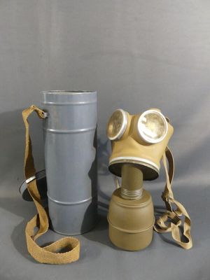 a gas mask and a bucket on the table